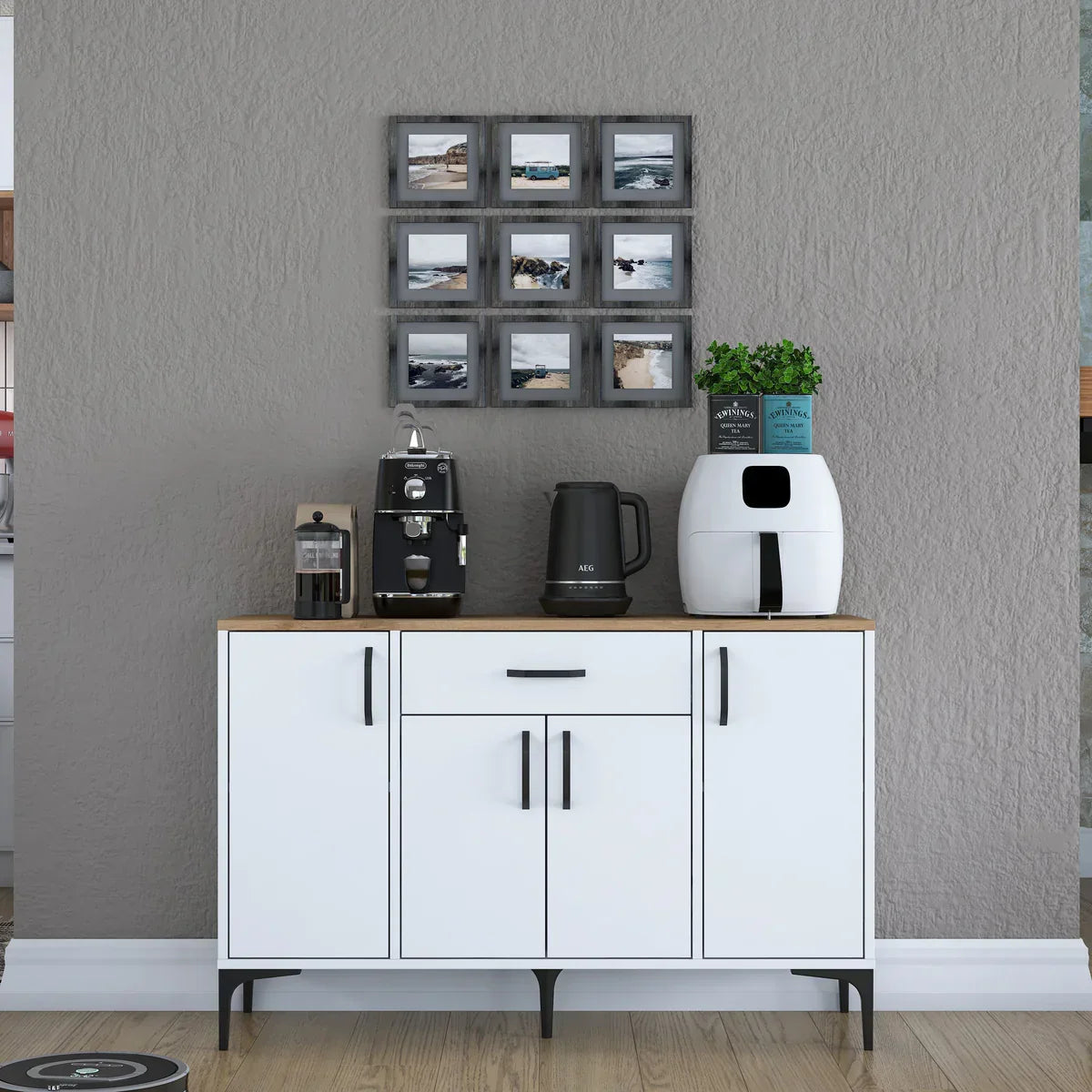 White cabinet with coffee maker, espresso machine, and coffee beans against a gray wall.