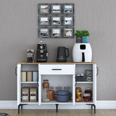Kitchen island with appliances and decor against a gray wall