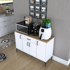 White kitchen cabinet with wooden top holding kitchen appliances and decor items in a room.