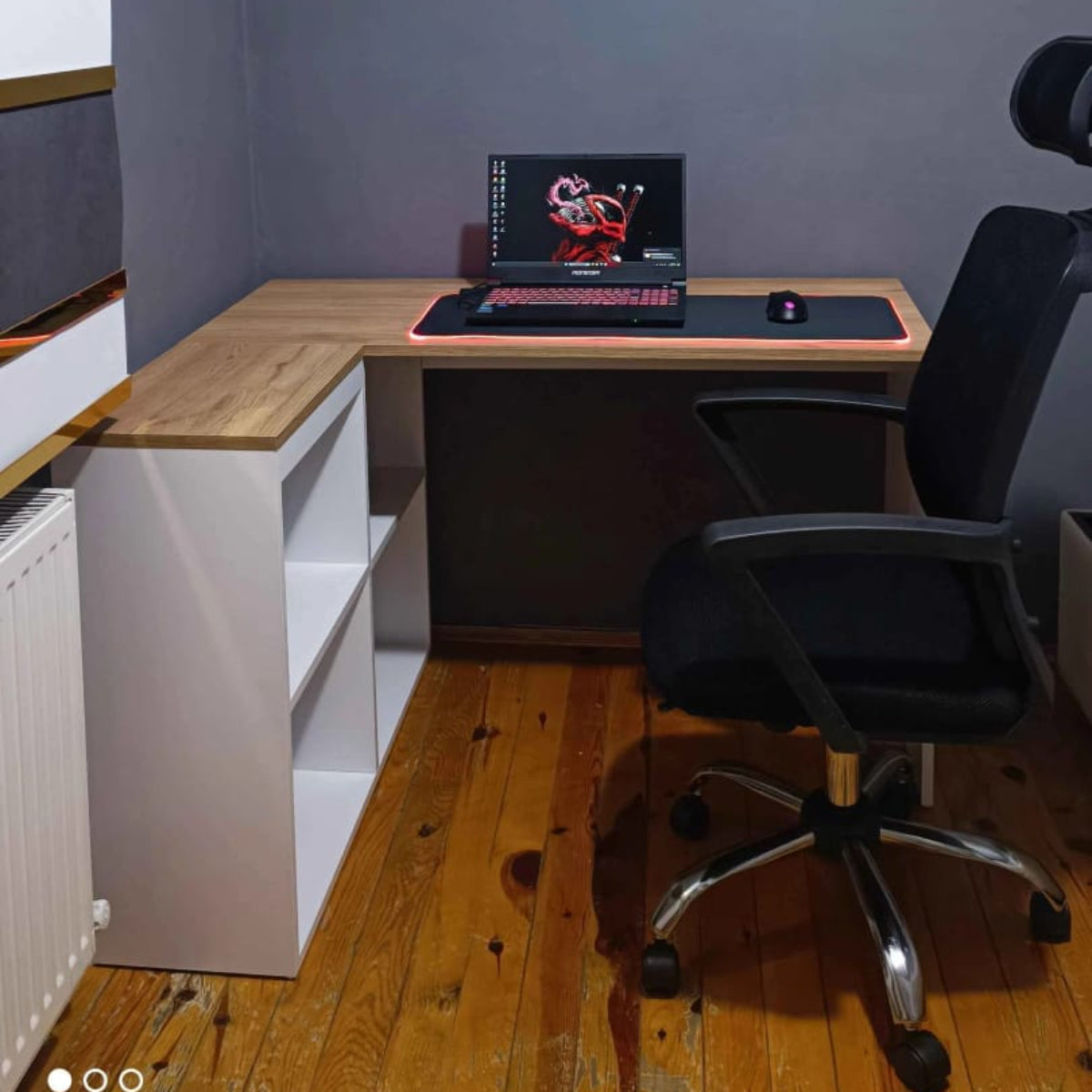 Home office setup with a desk, chair, and shelves against a gray wall.