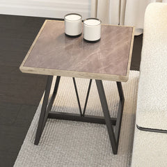 Small side table with marble-like top and black metal legs in a living room setting.