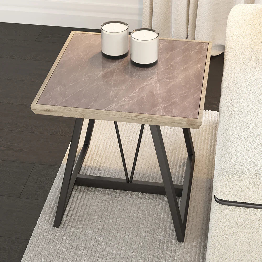 Small side table with marble-like top and black metal legs in a living room setting.