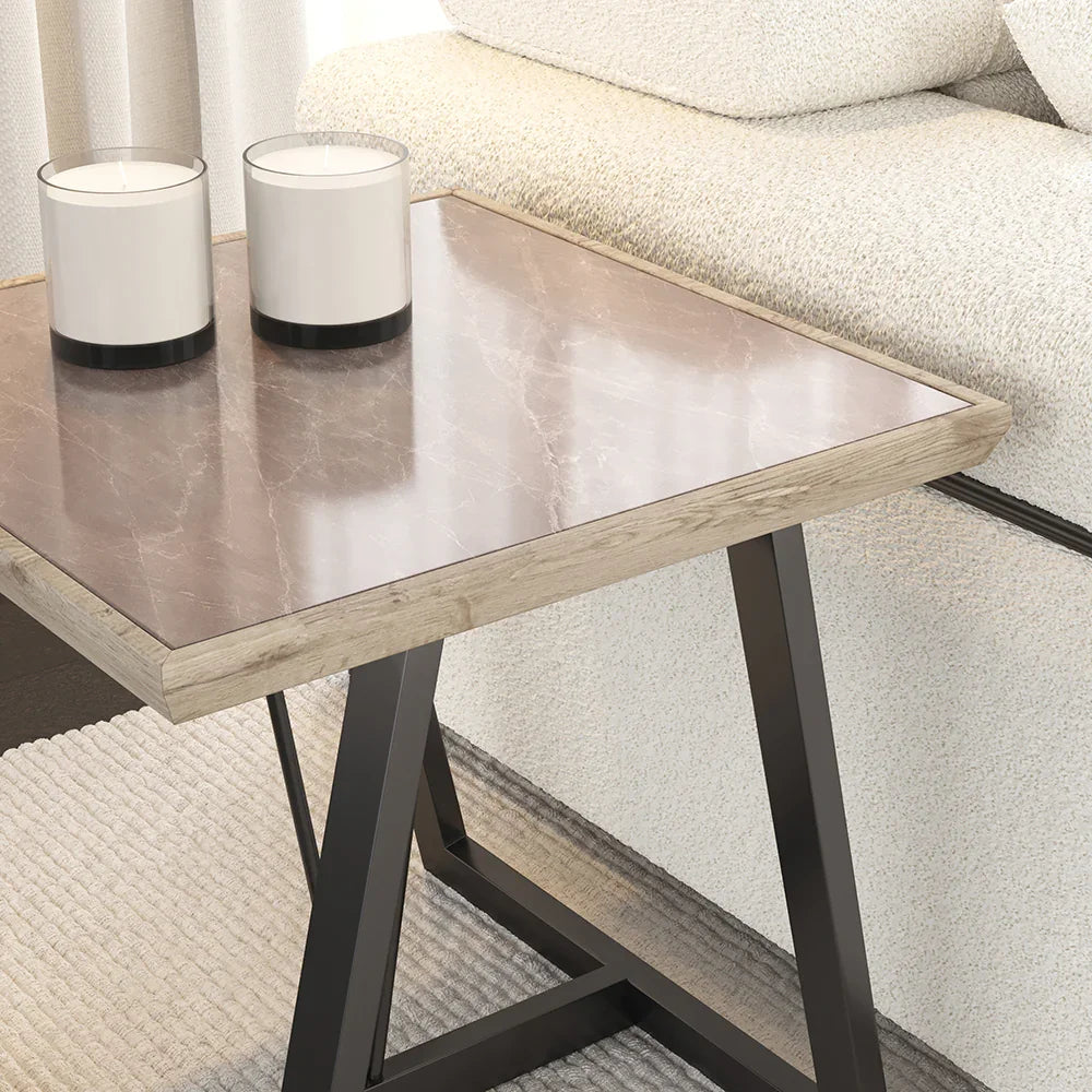 Small wooden table with black metal legs in a living room setting.