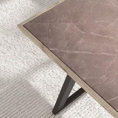 Marble-patterned table with a black metal leg on a textured white surface
