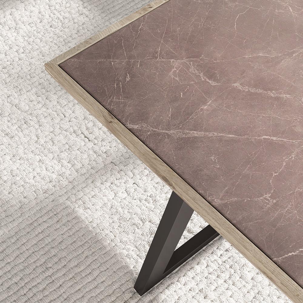 Marble-patterned table with a black metal leg on a textured white surface