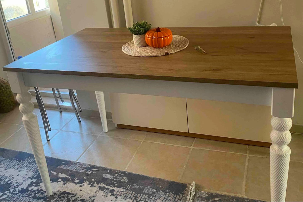 Wooden table with decorative items on a tiled floor