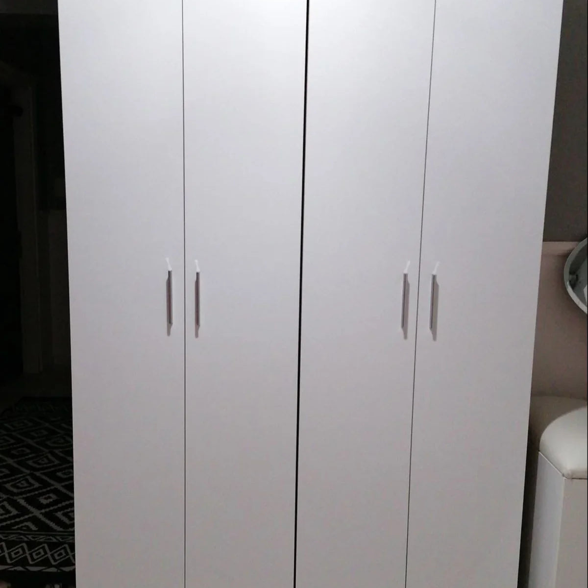 White wardrobe with wooden top and legs in a room setting