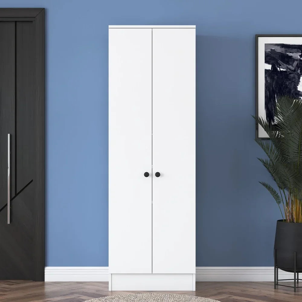 White wardrobe against a blue wall with a black door and plant in the corner.