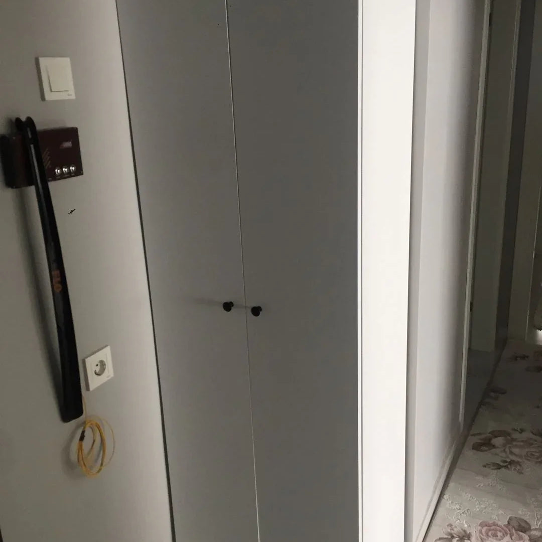 White wardrobe with a floral-patterned rug on the floor
