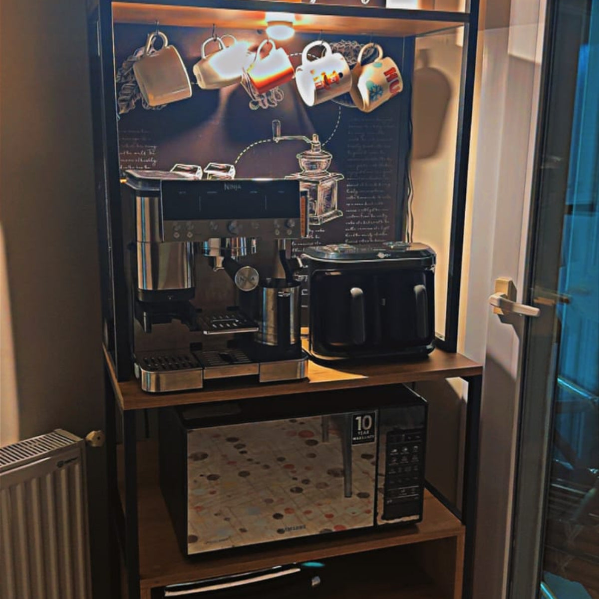 Coffee machine and microwave on a wooden stand with a coffee-themed display.
