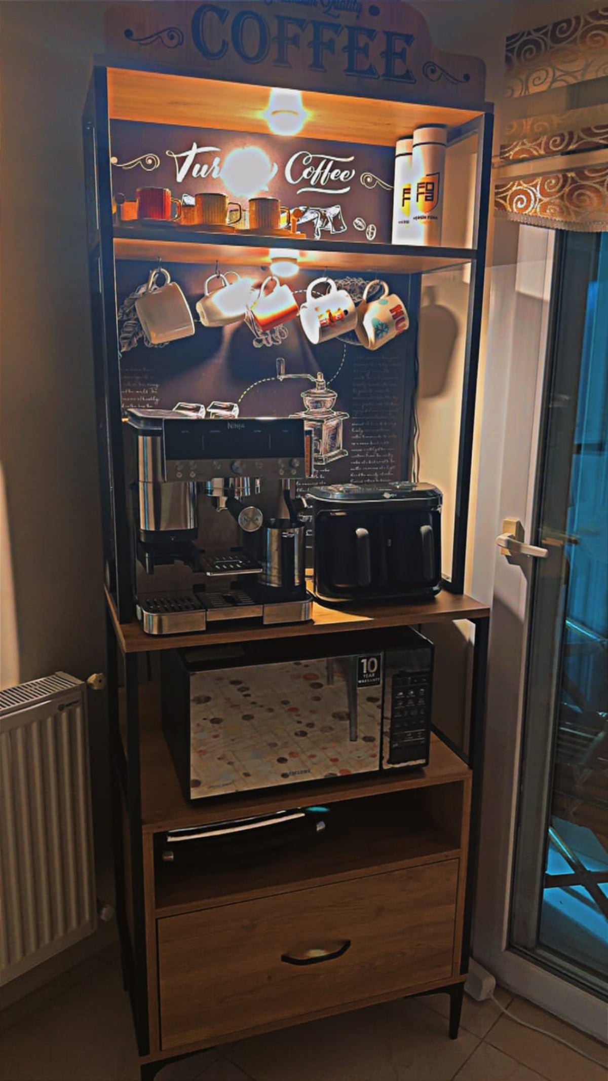 Coffee machine and microwave on a wooden stand with a coffee-themed display.