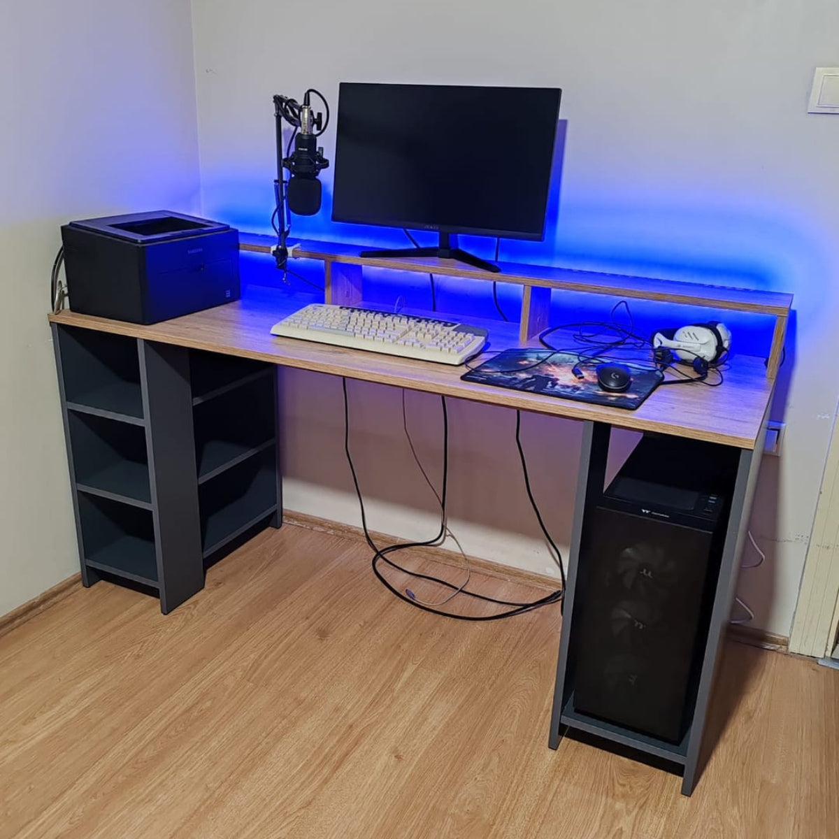 Home office setup with a desk, computer monitor, keyboard, and speakers.