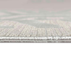 Close-up of a textured silver strip on a light pink background