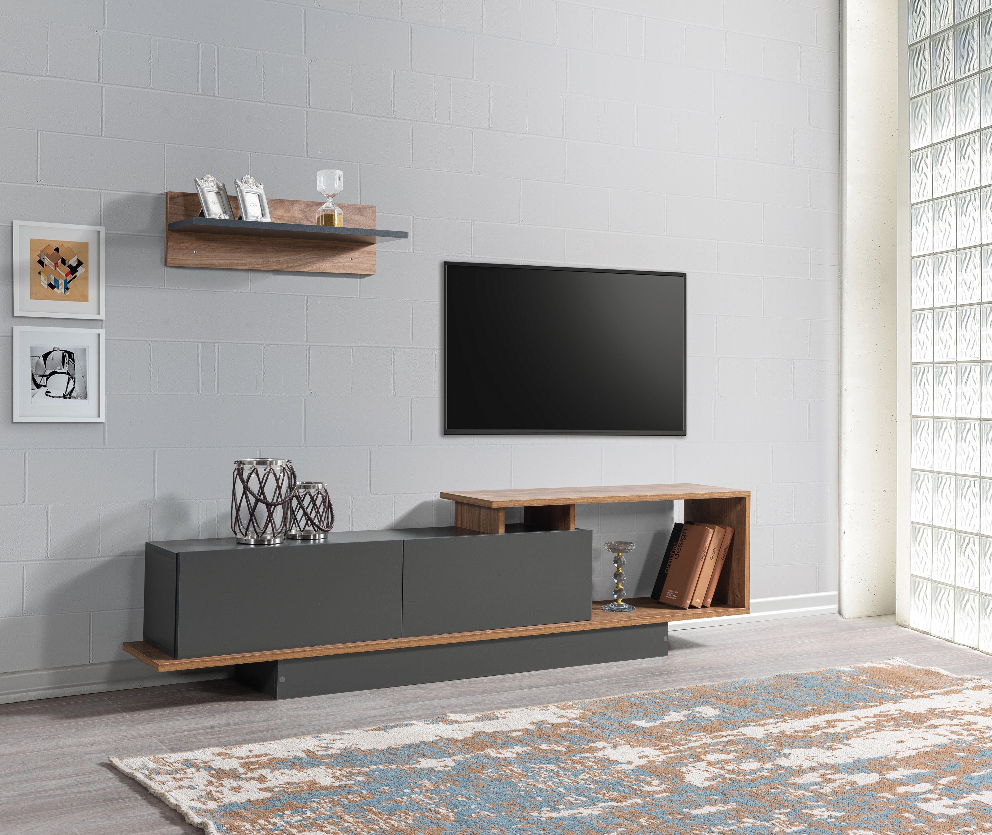 Modern living room with a TV stand, television, and decorative items.