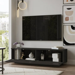 Modern living room with a black TV stand, television, and decorative items.