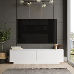 Modern living room with a white entertainment console, black TV, and decorative items.