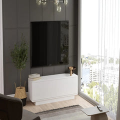 Modern living room with a white entertainment console, TV, and decorative items.