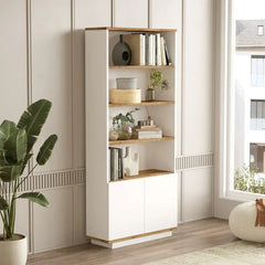 Tall white bookshelf with wooden shelves in a room with a plant and window.