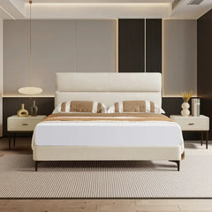Modern bedroom with a white bed, nightstands, and decorative elements.