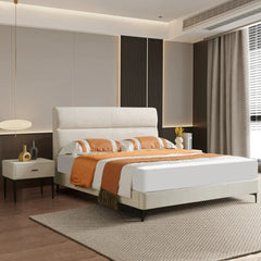 Modern bedroom with a bed, nightstands, and decorative items.