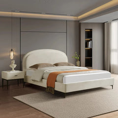 Modern bedroom with a white bed, nightstands, and decor elements.