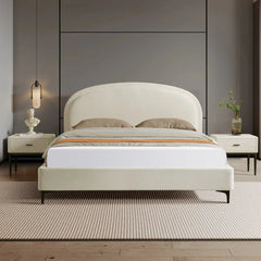 Modern bedroom with a white bed and matching nightstands against a gray wall.