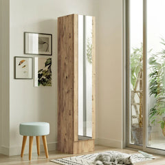 Tall wooden mirror with glass panel in a room with a window and decorative items.