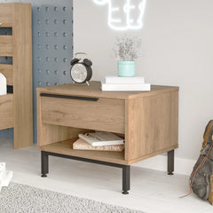 Wooden nightstand with black legs in a room setting