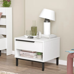 White nightstand with black legs in a room setting