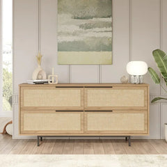 Wooden sideboard with wicker doors in a room with a painting and plants.