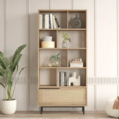Wooden bookshelf with decorative items against a light wall