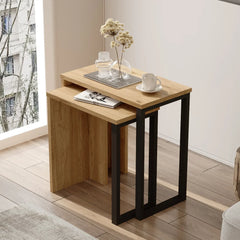 Wooden nesting tables in a room with a window and plant
