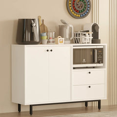 White sideboard with kitchen appliances in a room with a dining area.