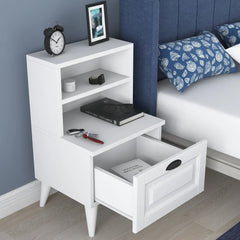White nightstand with open drawer in a bedroom setting