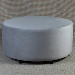 Round gray ottoman on a textured gray background