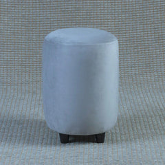 Round gray ottoman on a textured gray background