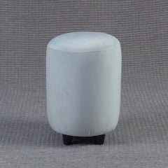 Round light gray ottoman on a textured gray background