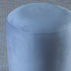 Blue ottoman on a checkered floor