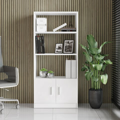 White bookshelf with books and decor items against a striped wall with a plant on the right.