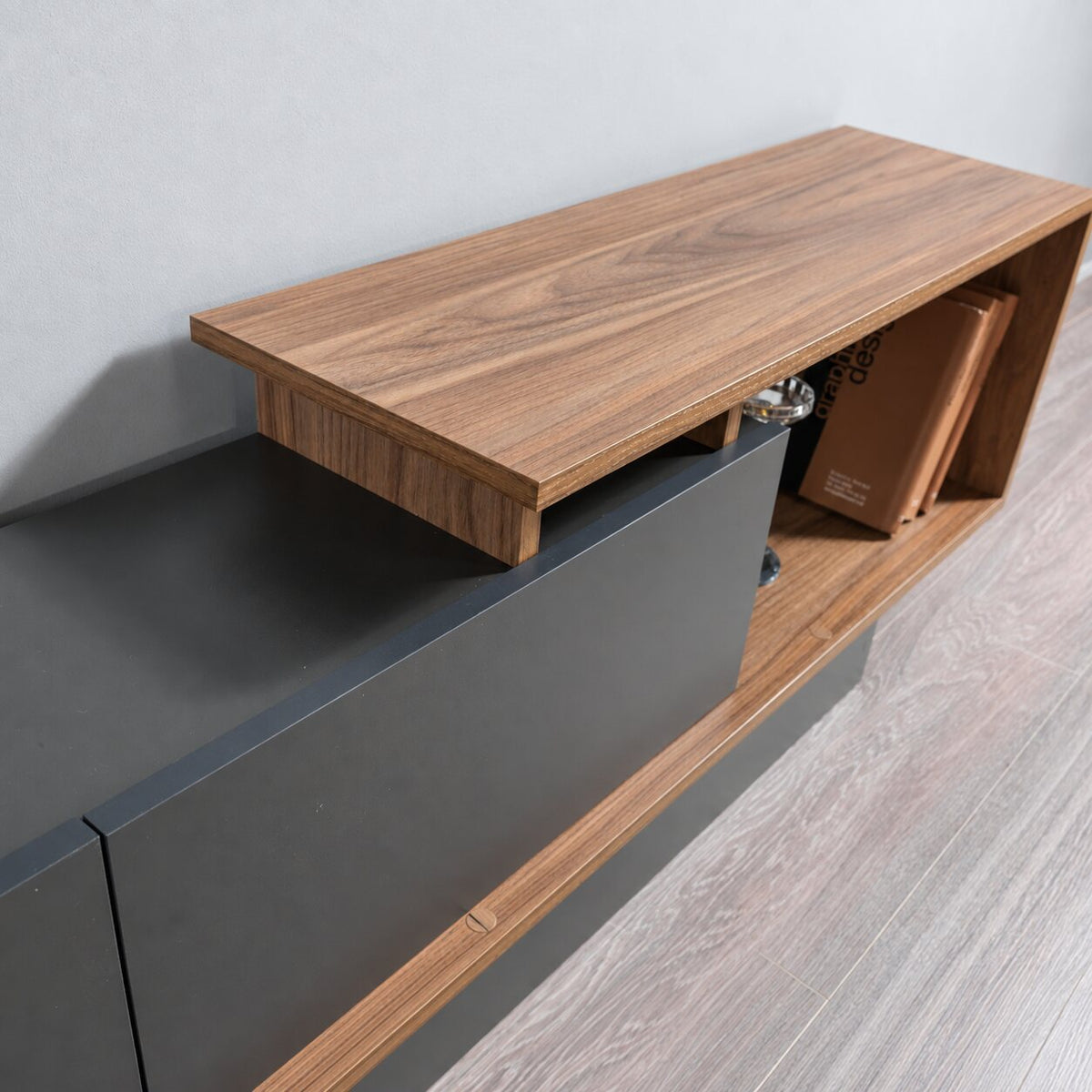 Close-up of the AshLine TV unit’s wood top and grey cabinet